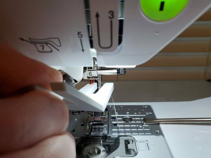 how to use the clearance plate to insert the sewing needle