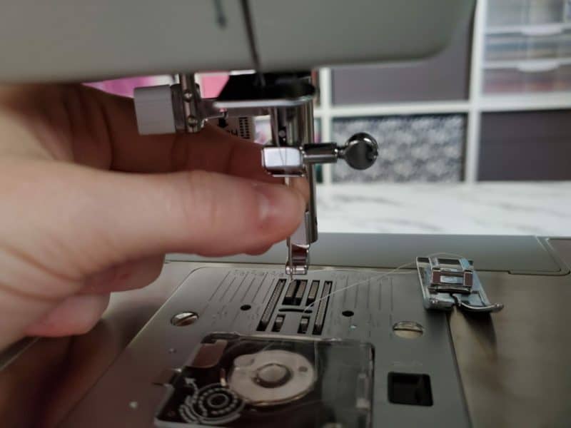 removing the presser foot to change the sewing machine needle