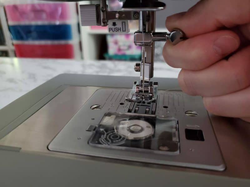 twist the screw towards you counterclockwise on singer heavy duty sewing machine