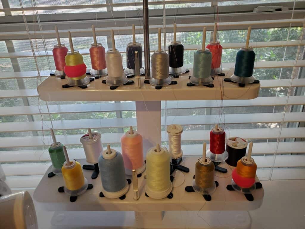 types of machine embroidery threads on a stand