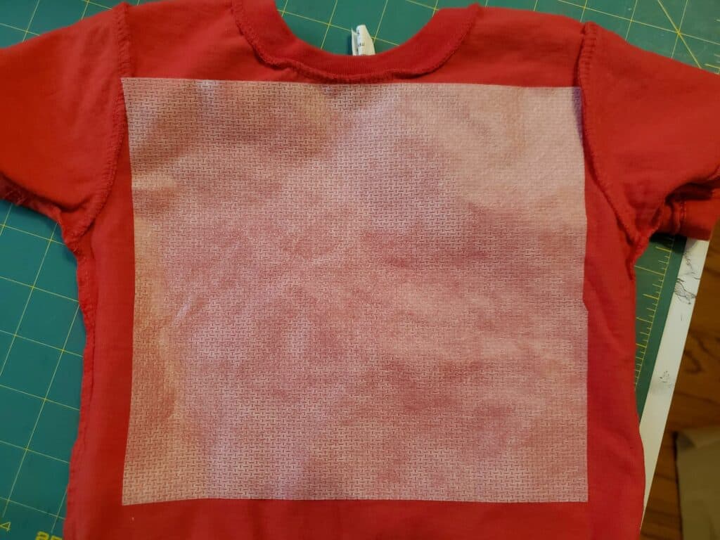 place stabilizer on back of t-shirt to be embroidered