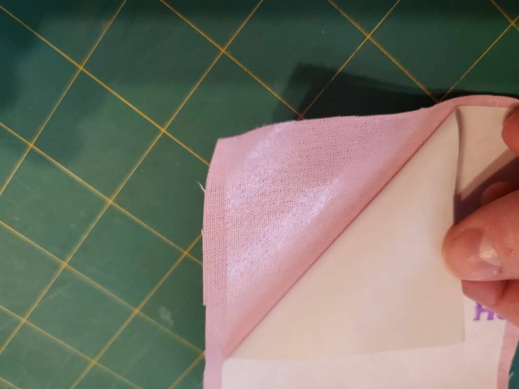 remove paper backing to see sticky side remaining on the applique