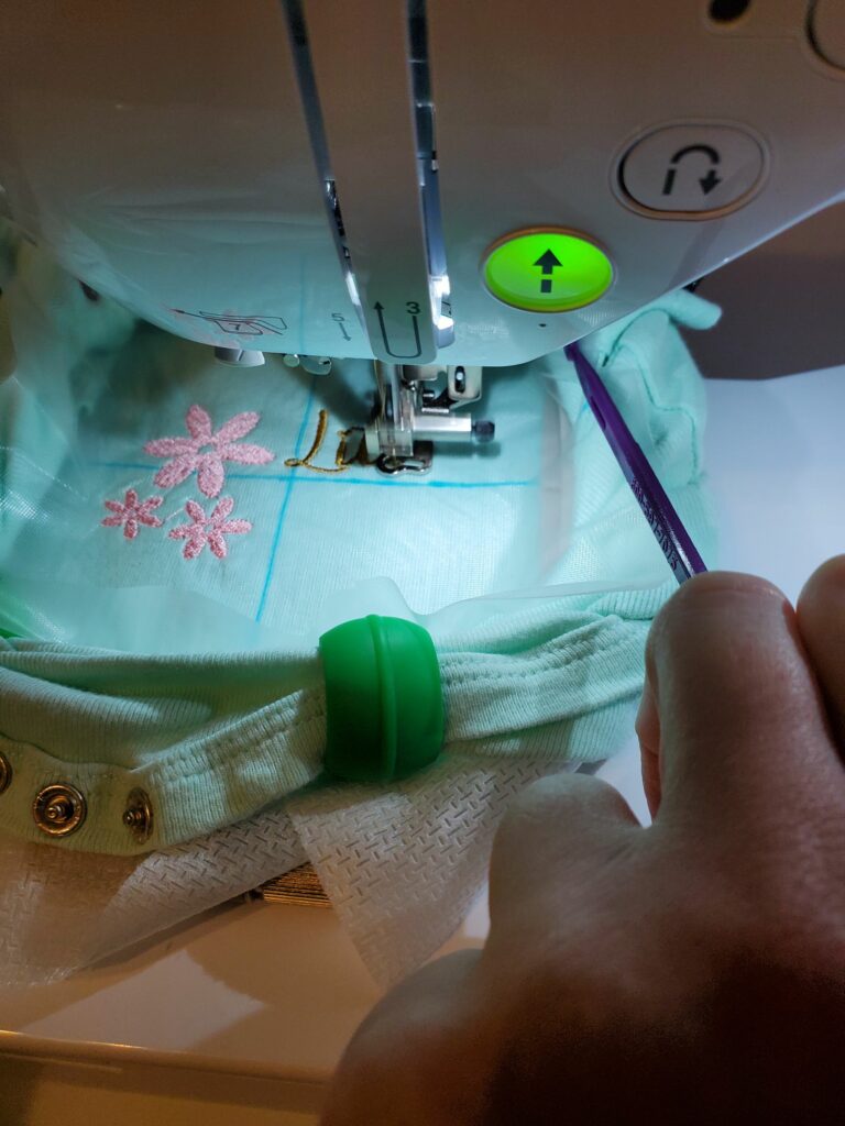 how to keep fabric and clips from hitting embroidery needle arm