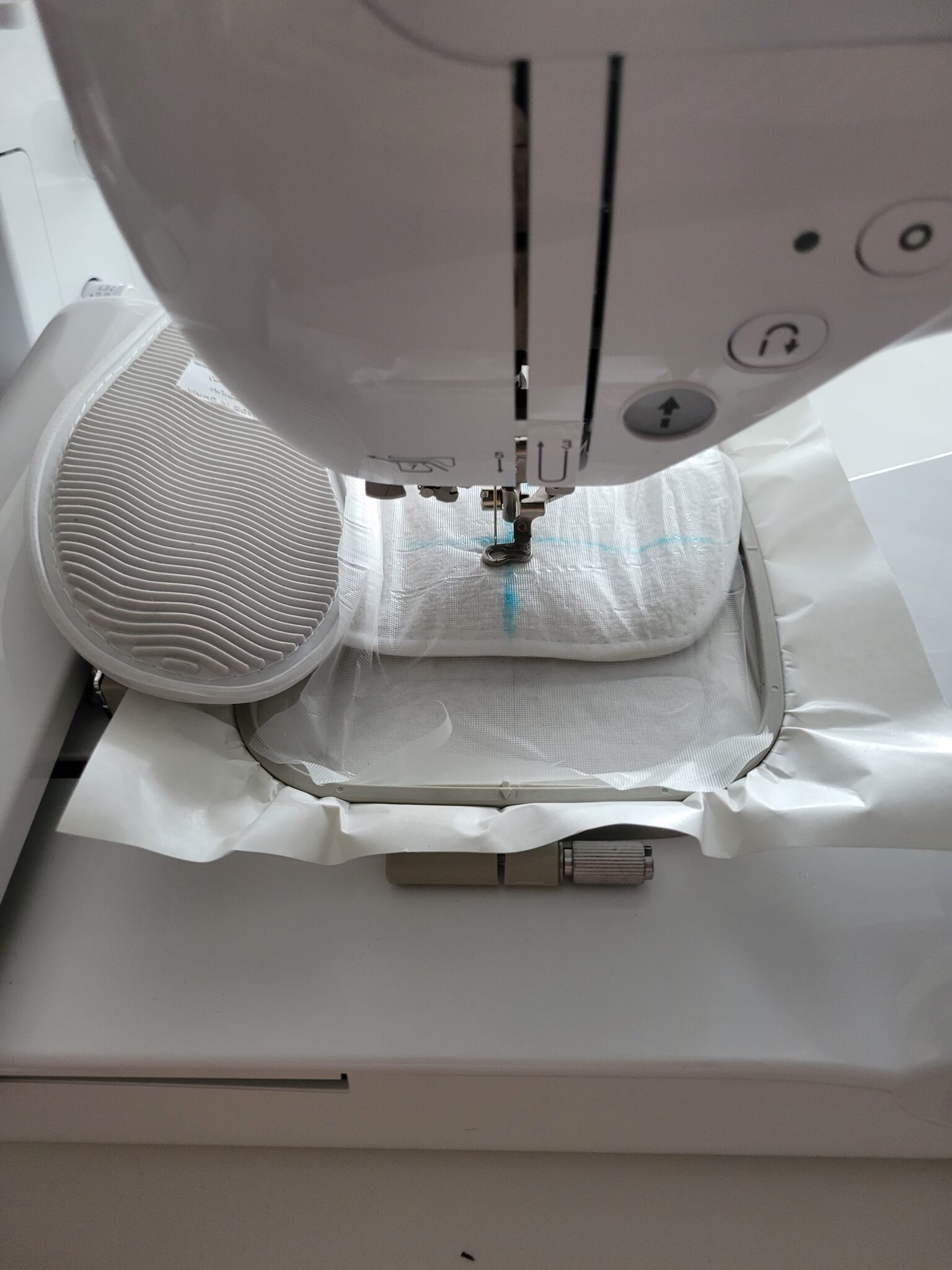 placing the slipper under the embroidery machine