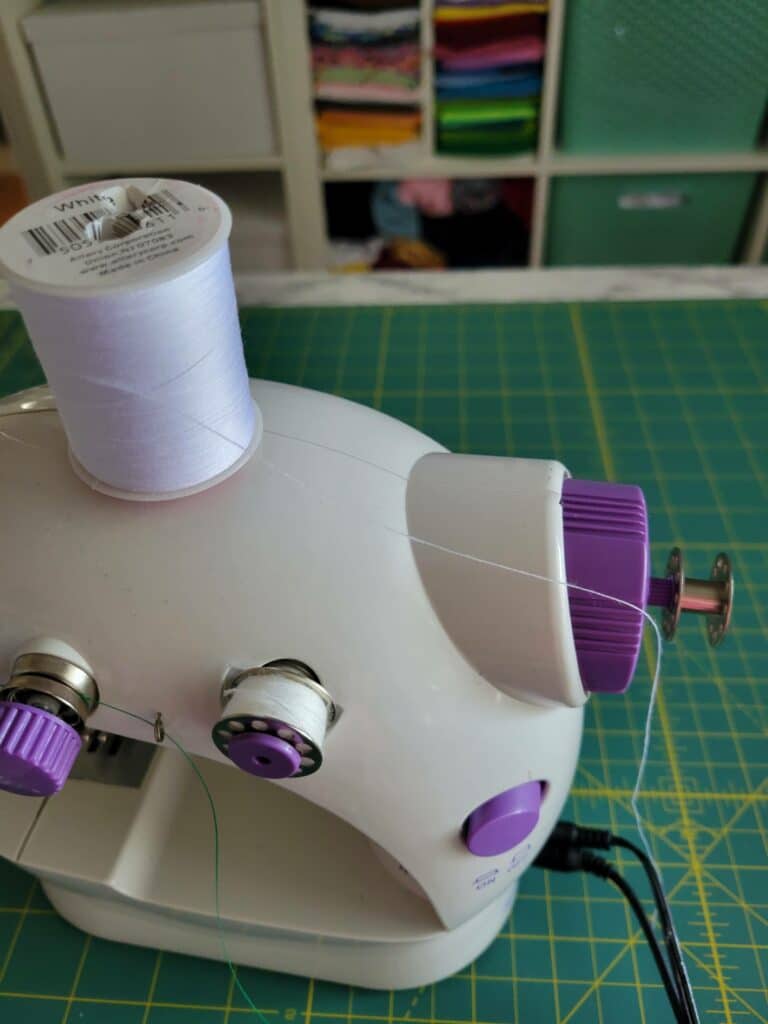 place bobbin thread on top of spool pin