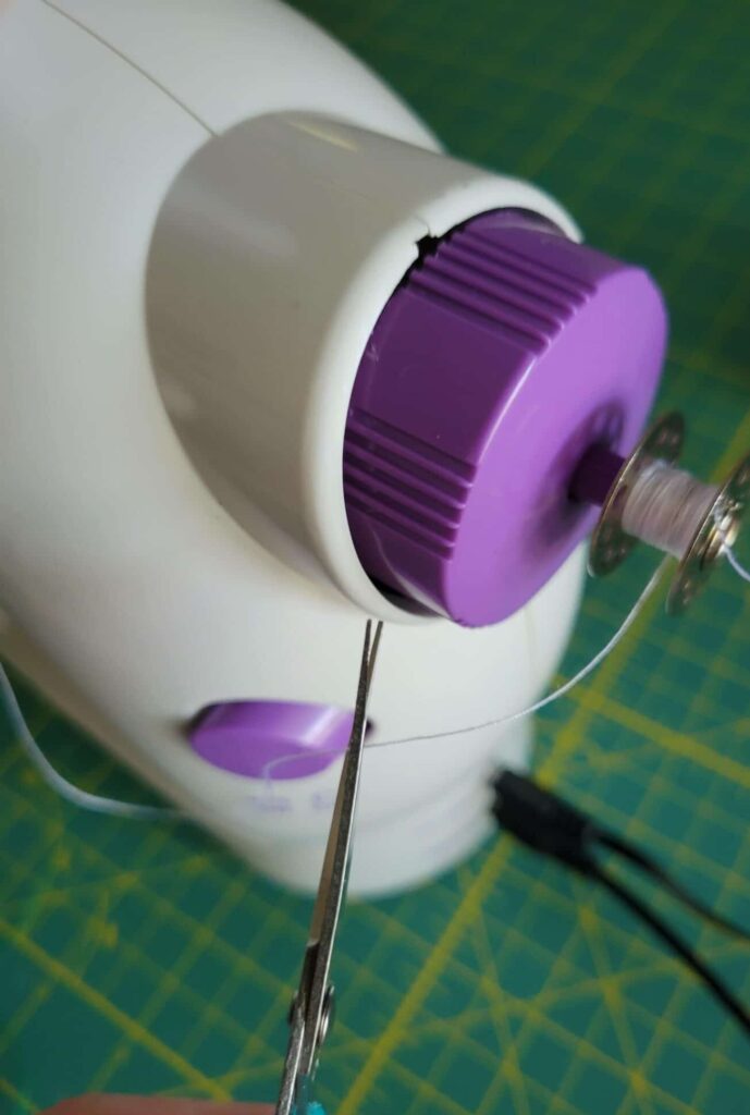 trim bobbin thread with scissors