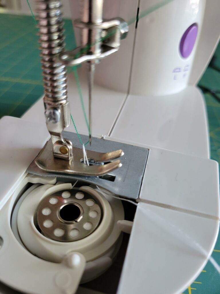 remove needle plate cover to pull up bobbin thread to start sewing