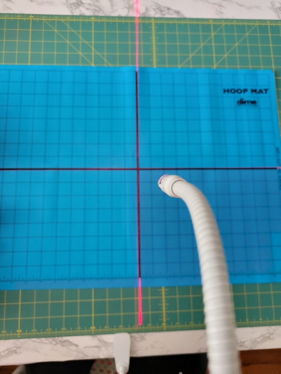 adjust the laser so it is directly over the mat