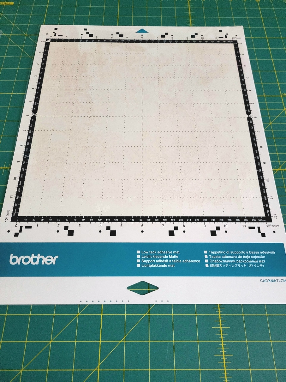 Low tack adhesive mat